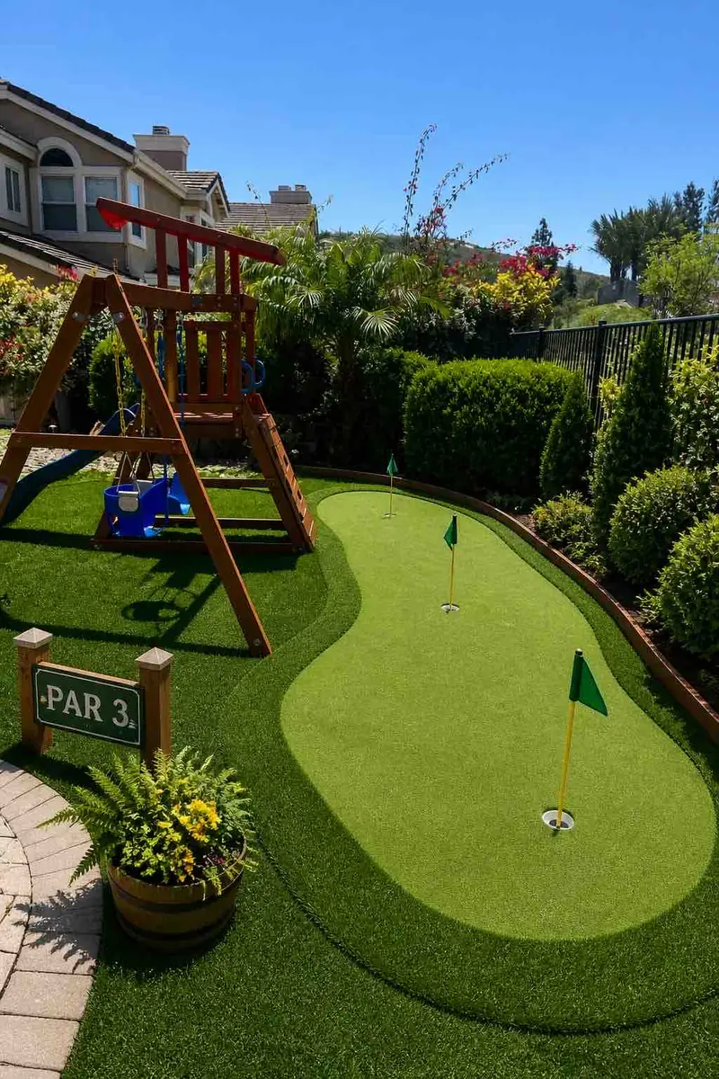 A putting green beside a play set